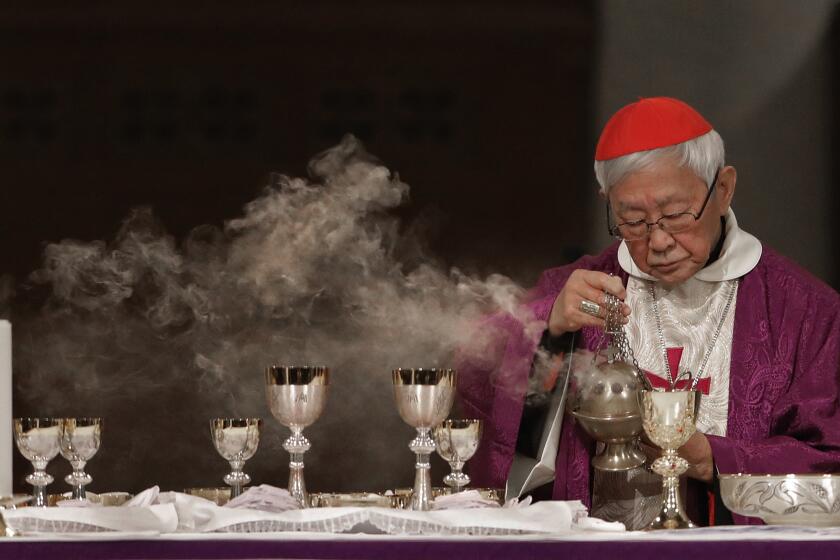 FILE - Cardinal Joseph Zen, a vocal opponent of attempts by Beijing and the Vatican at rapprochement, presides over a vigil Mass for Bishop Michael Yeung in Hong Kong, Thursday, Jan. 10, 2019. Five conservative cardinals are challenging Pope Francis to affirm Catholic teaching on homosexuality and female ordination. They've asked him to respond ahead of a big Vatican meeting where such hot-button issues are up for debate. The cardinals on Monday published five questions they submitted to Francis, known as “dubia.” (AP Photo/Vincent Yu, file)