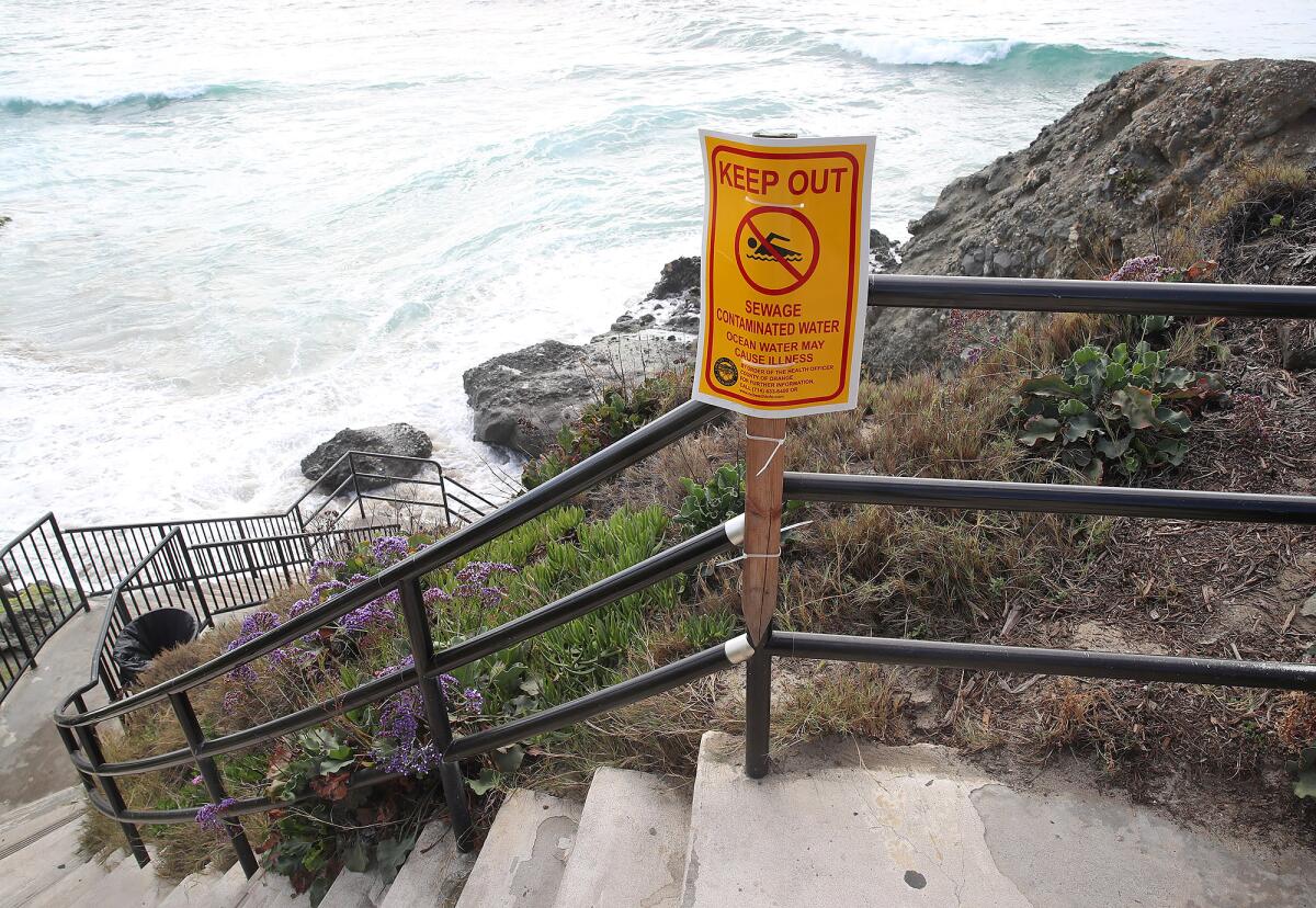A sign warning beachgoers at the Cress Street stairs after a sewage spill in Laguna Beach.
