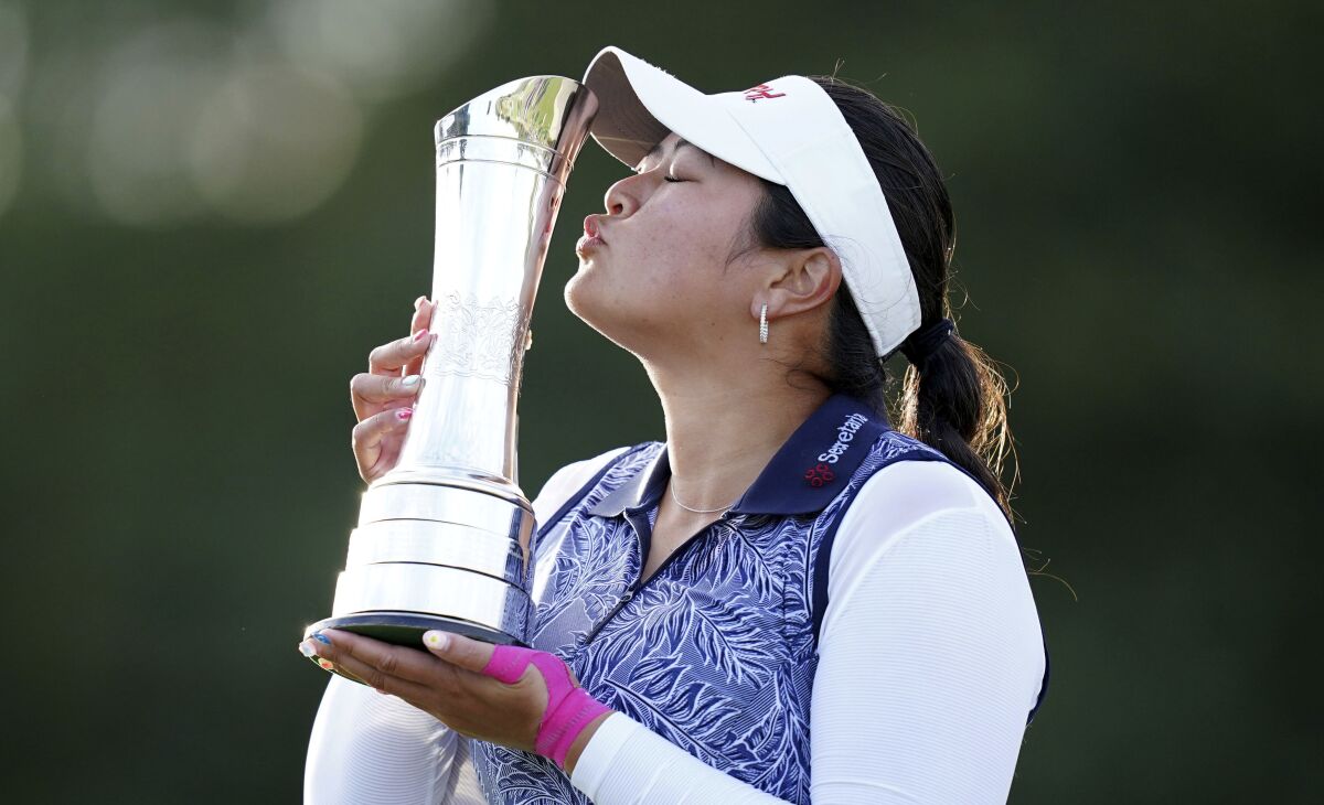 Lilia Vu kisses her trophy.