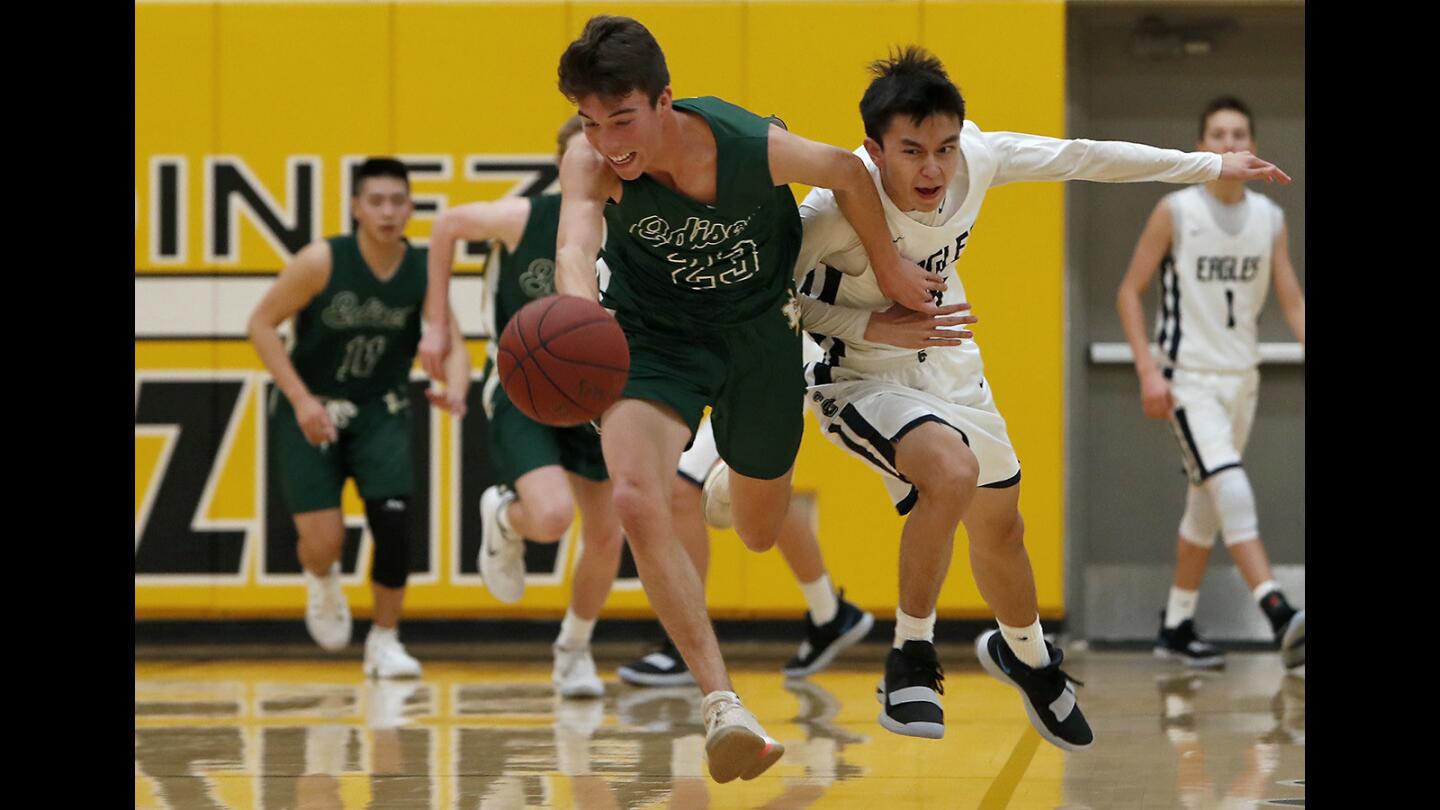 Edison High's Bradley Luna, left, steals the ball away from Calvary Chapel's Kyle Thorin during the first half in the Grizzly Invitational at Godinez High on Wednesday, November 28, 2018