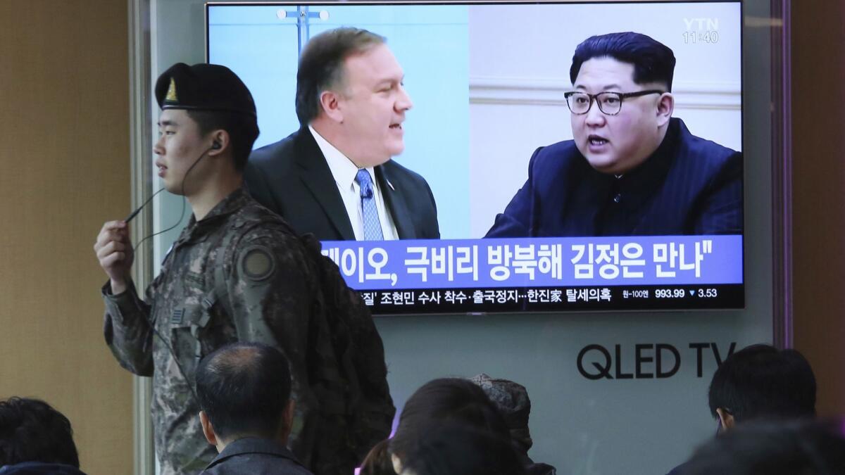 Images of CIA Director Mike Pompeo, left, and North Korean leader Kim Jong Un on a South Korean news program on a video screen at the Seoul train station on April 18, 2018.