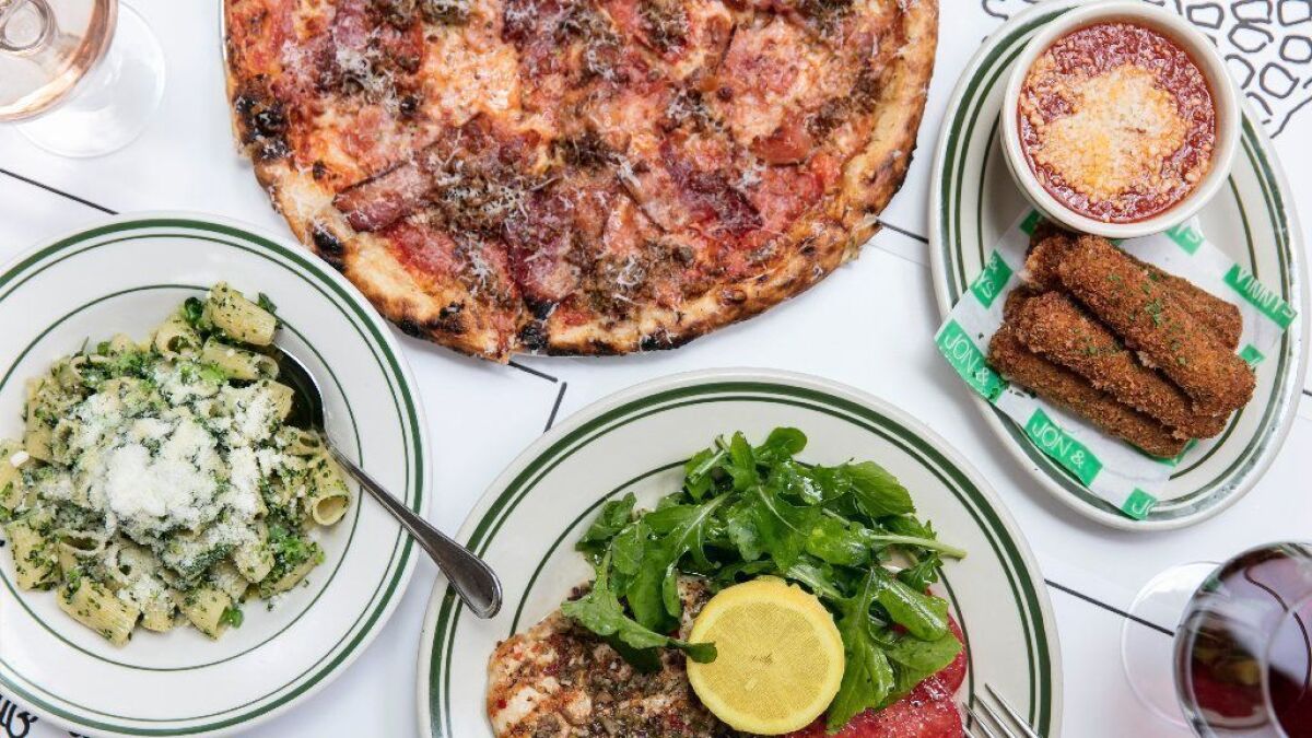 A lunch spread at Jon & Vinny's in Brentwood includes the Roman Gladiator pizza, mozzarella sticks, grilled chicken and rigatoni with broccolini.