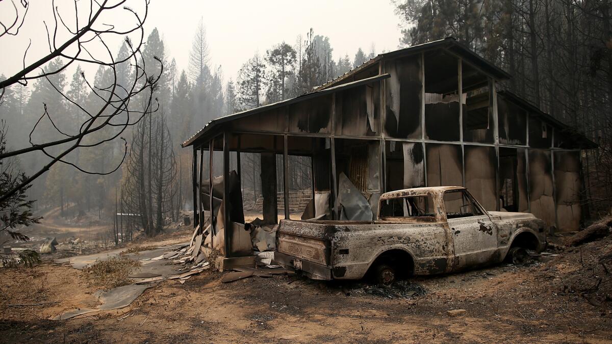 A burned-out truck sits in front of a structure that was destroyed by the King fire on Sept. 19 near Pollock Pines, Calif.