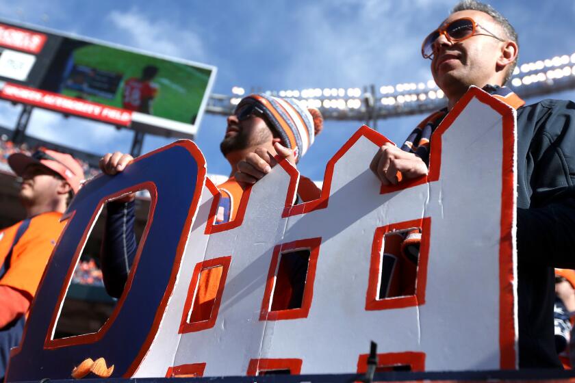 Fans hold a 'defense' sign before Denver's victory over New England in the AFC championship game. The Broncos had the NFL's top-ranked defense this season and face the Panthers' top-scoring offense in Super Bowl 50.