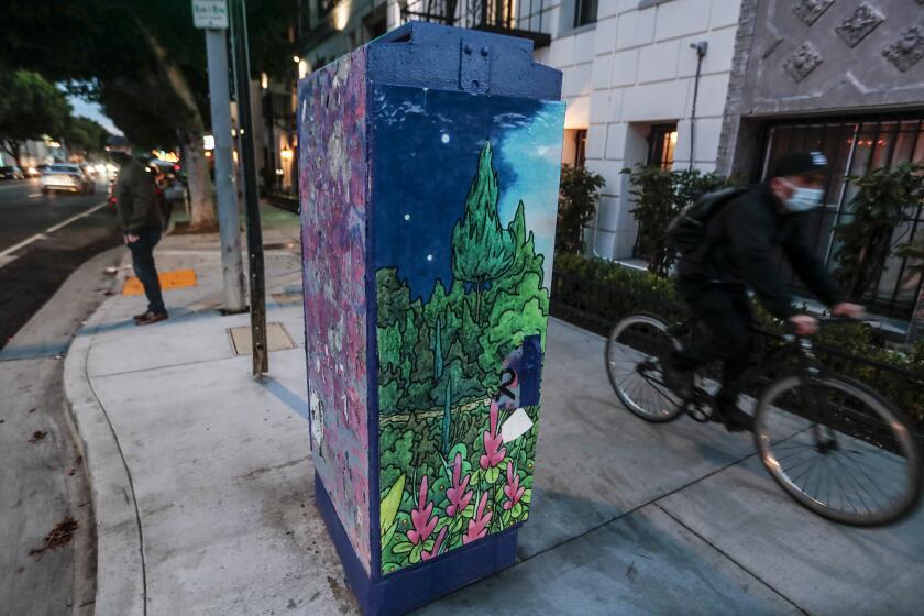 Los Angeles, CA, Friday March 12, 2021 - Artist Tarrence Whitten, an artist whose artwork was commissioned by the city to adorn a Silverlake power box located on Vermont St., in Los Feliz. The vinyl wrap has been torn off on alll but one side, revealing a graffiti laden box. (Robert Gauthier/Los Angeles Times)