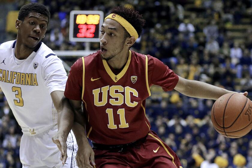 USC guard Jordan McLaughlin (11) tries to drive past California guard Tyrone Wallace in the first half Thursday night in Berkeley.