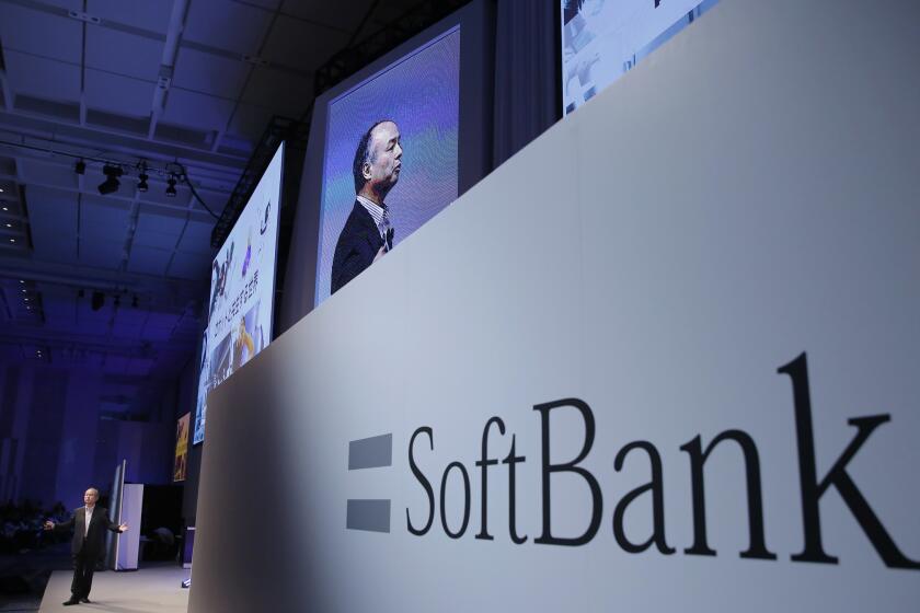 In this July 20, 2017, file photo, SoftBank Group Corp. Chief Executive Officer Masayoshi Son, left, speaks during a SoftBank World presentation at a hotel in Tokyo. Japanese technology conglomerate SoftBank has reached a deal with Uber to invest billions in the ride-hailing giant. Uber Technologies Inc. confirmed the investment in a statement Sunday, Nov. 12, without giving details.