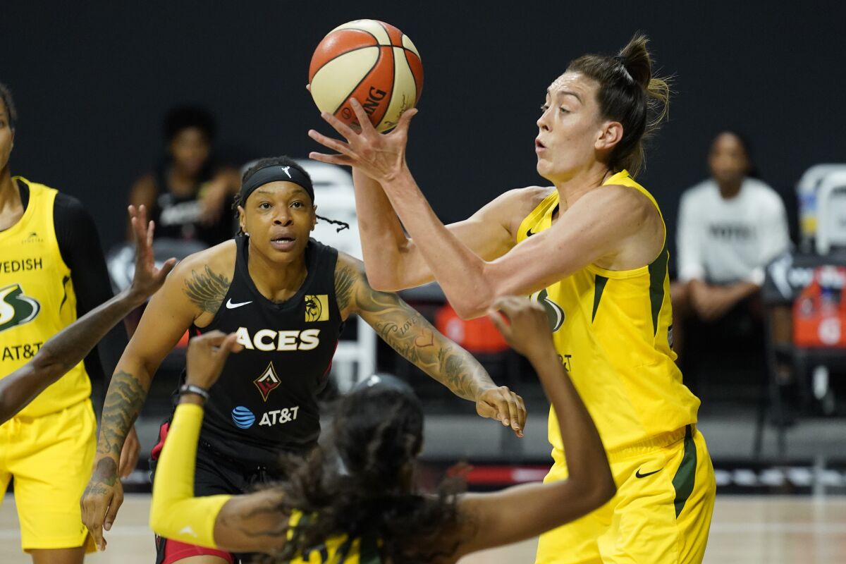 Seattle Storm forward Breanna Stewart grabs a rebound away from Las Vegas Aces forward Emma Cannon.