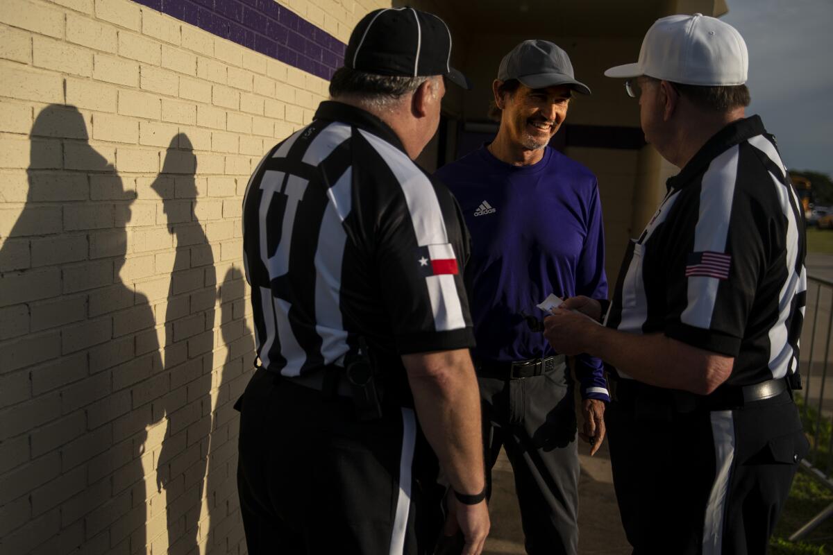 Mount Vernon High School Tigers head coach Art Briles chats with the referees before a game at Bonham High School on Friday in Bonham, Tex.