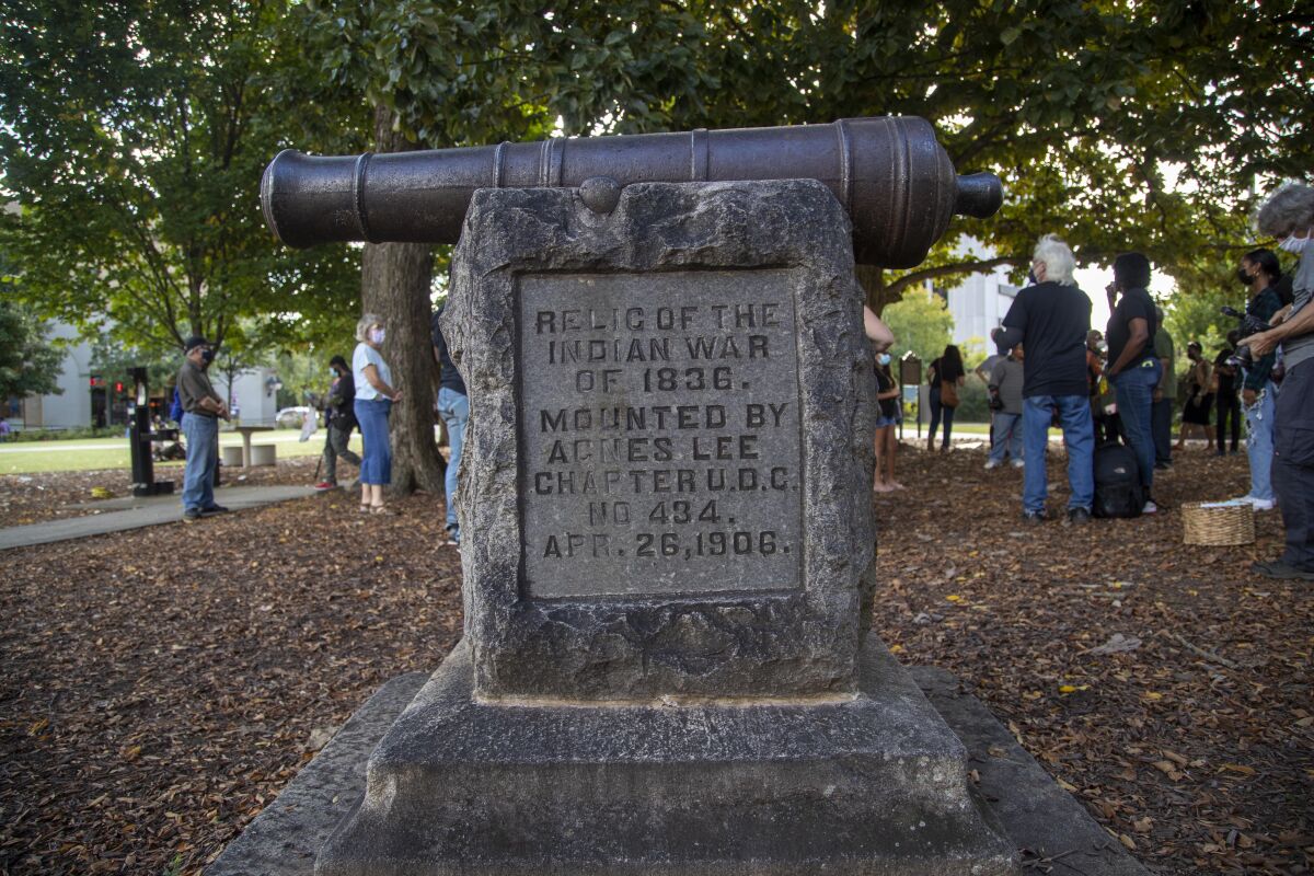 A cannon monument, installed by the United Daughters of the Confederacy in 1906, is displayed near the Old DeKalb County courthouse in downtown Decatur, Ga., Monday, Oct. 11, 2021. A Georgia county unanimously voted Tuesday to remove the “genocide cannon” from the city square where it resided for more than a century. The cannon in Decatur has ties to the Indian War of 1836 and has become increasingly controversial, drawing criticism from local activists who say it represents the brutal suffering of thousands of Muscogee people who were removed from their native lands. (Alyssa Pointer/Atlanta Journal-Constitution via AP)