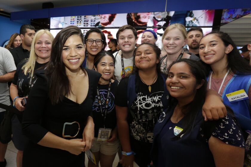 America Ferrera met blue-vested fans like Chloe Rodriguez (bottom right) at NBC's 'Superstore' activation at Comic-Con.
