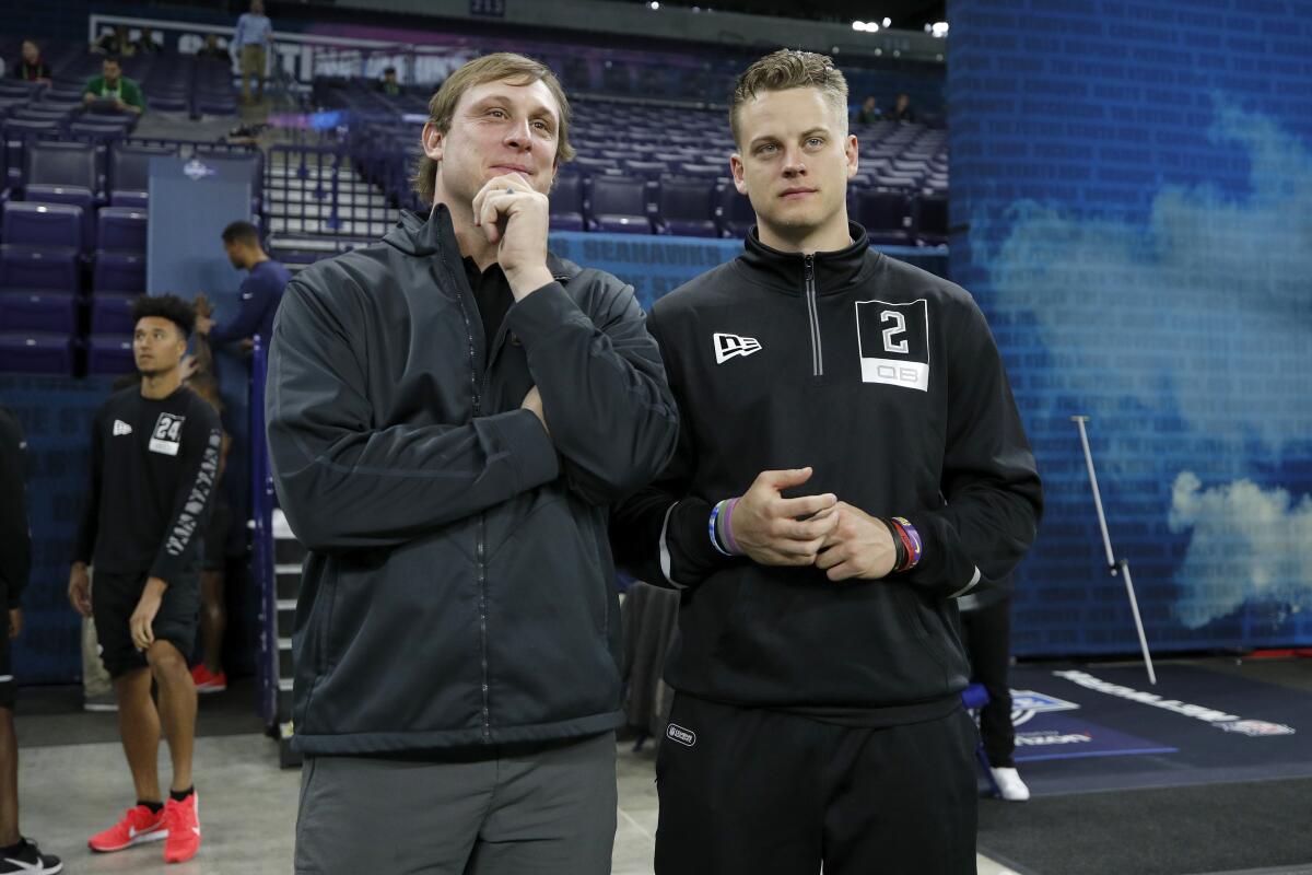 Former LSU quarterback Joe Burrow, right, speaks to former NFL quarterback Chad Pennington during NFL Scouting Combine on Thursday.