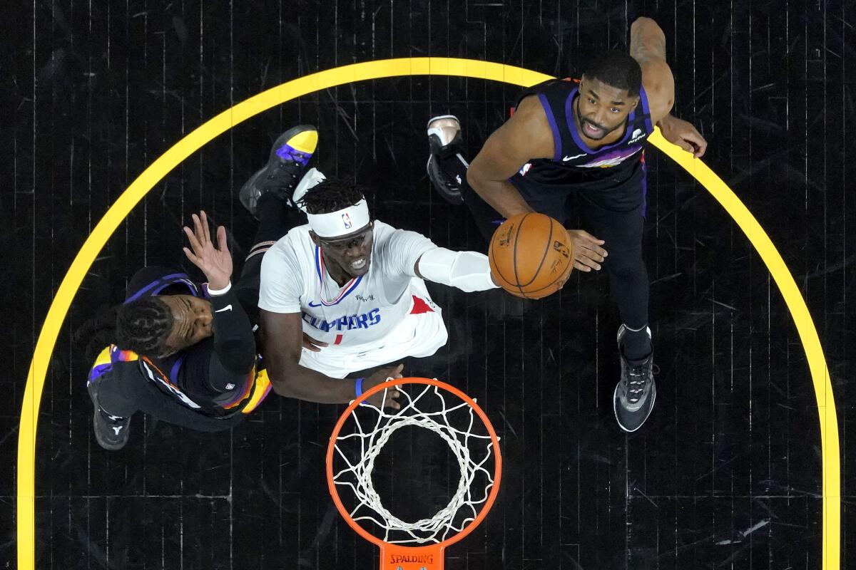 Reggie Jackson shoots between Jae Crowder, left, and E'Twaun Moore during the first half.