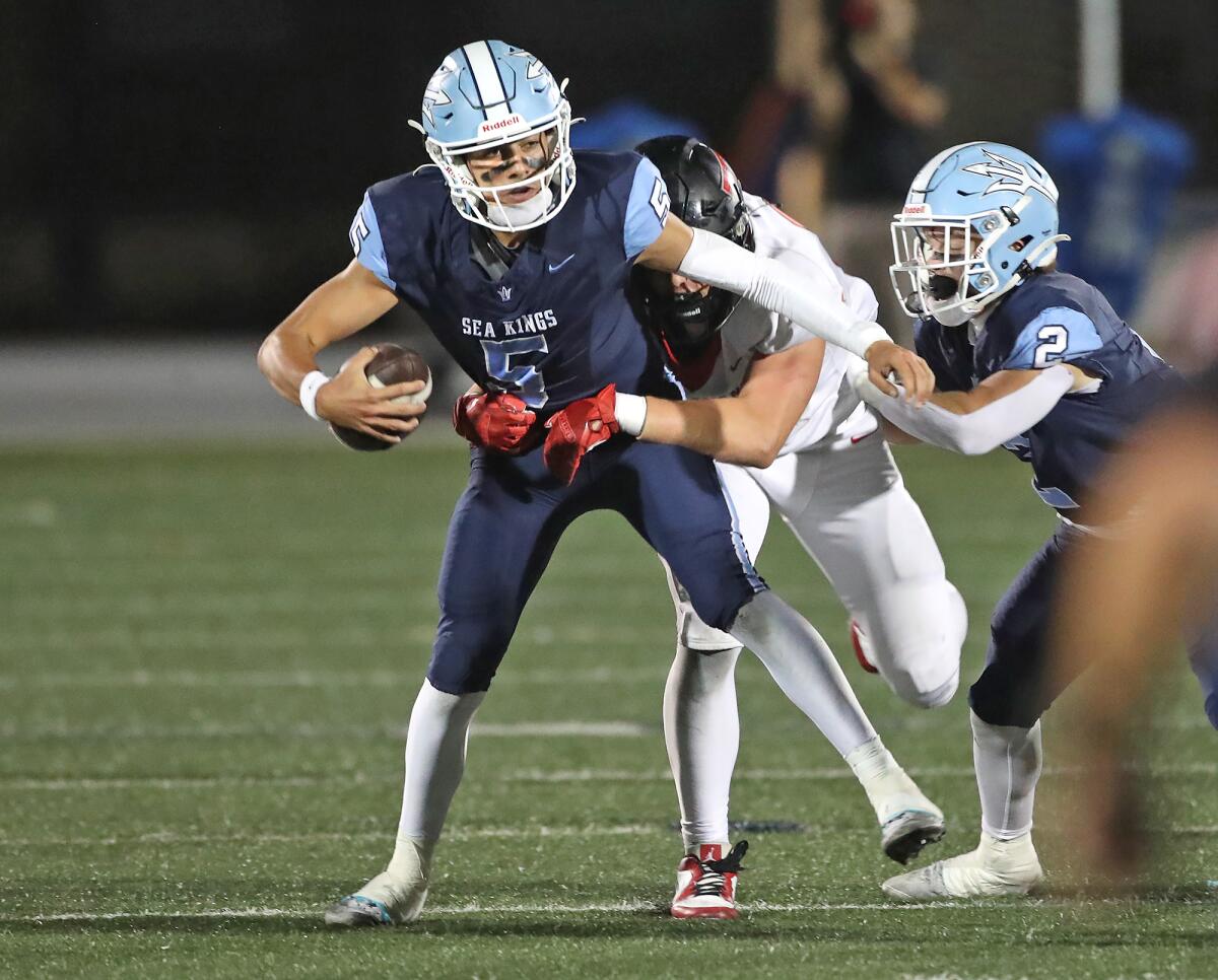 Corona del Mar quarterback Max Nashed (5) takes a sack in the first half against San Clemente on Friday.