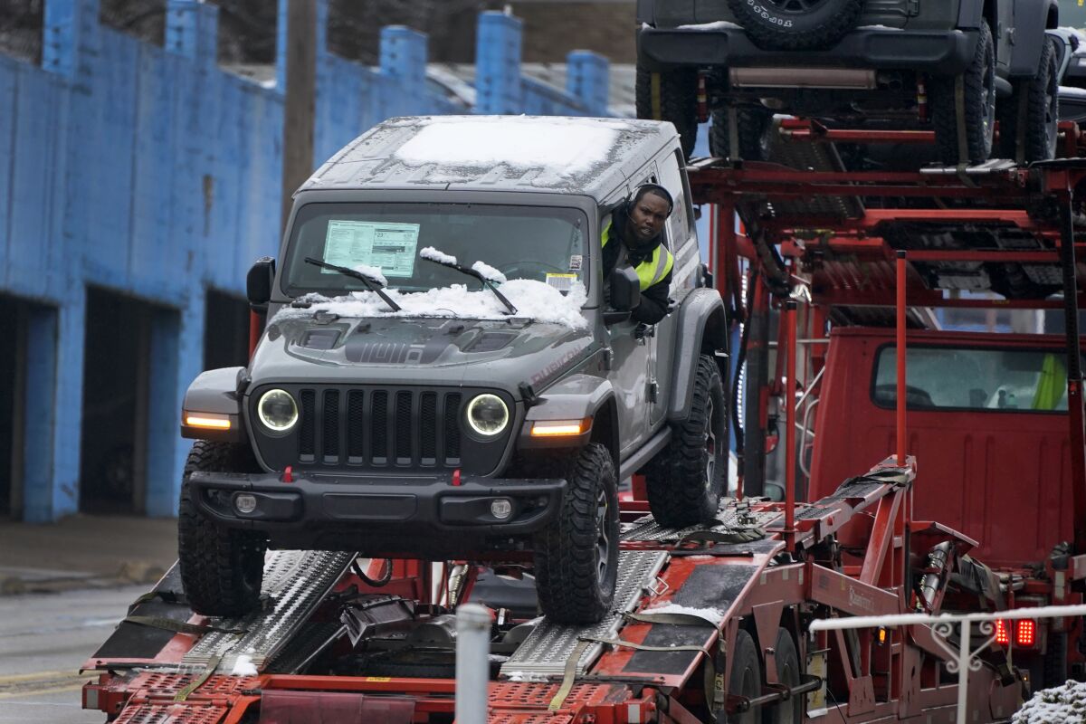 A new Jeep is delivered to a dealership in Pittsburgh on Monday, Jan. 23, 2023. On Friday, the Commerce Department issues its December report on consumer spending. (AP Photo/Gene J. Puskar)