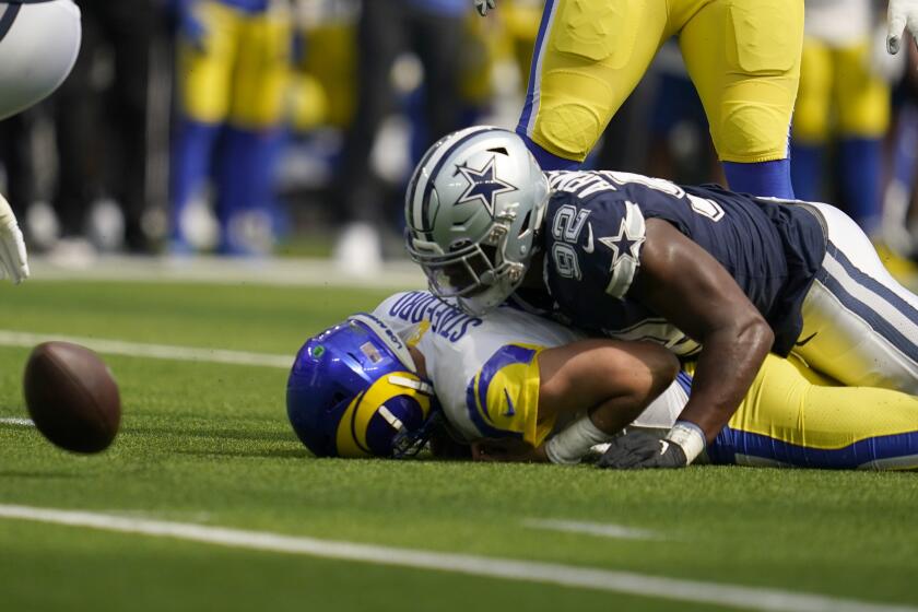 Los Angeles Rams quarterback Matthew Stafford (9) is sacked by Dallas Cowboys defensive end Dorance Armstrong