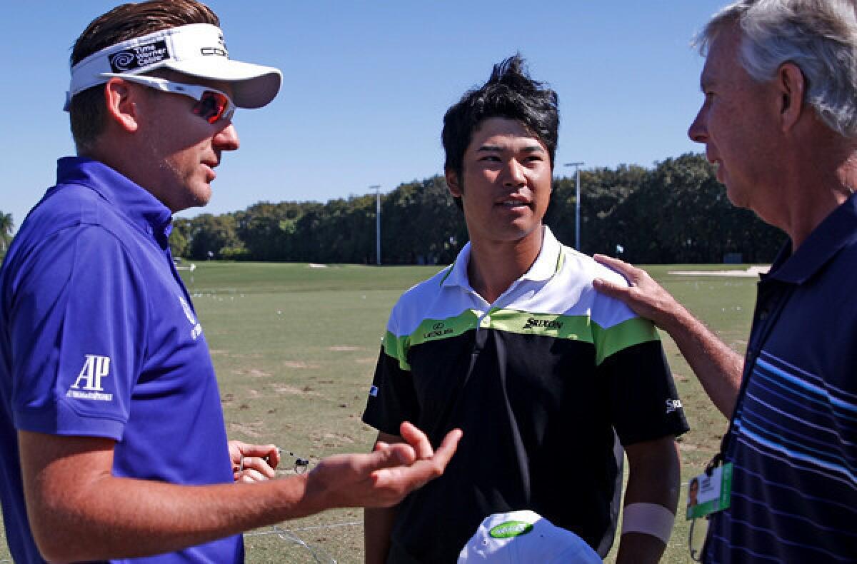 Ian Poulter, left, talks to Hideki Matsuyama, center and his interpreter Robert Turner at the driving range on Saturday morning before the third round of the Cadillac Championship at Doral, Fla.