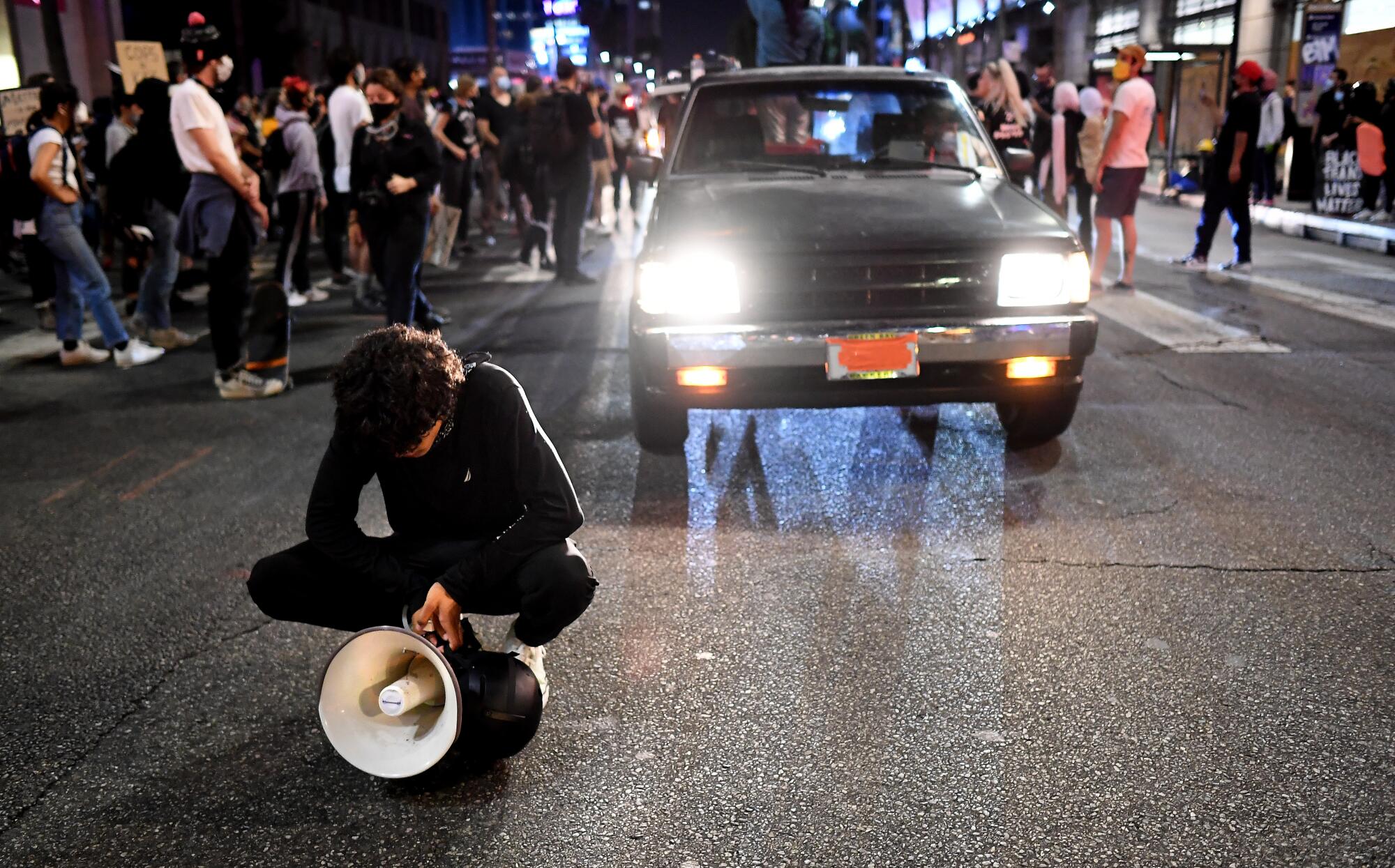 A protester prays on Sunset Boulevard. About 300 people marched through Hollywood on Thursday.