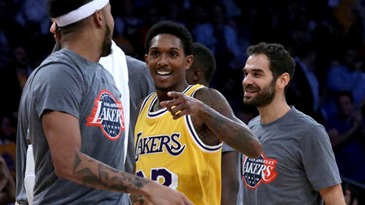 Lakers guard Lou Williams is congratulated by teammates after scoring a key basket against the Golden State Warriors in the fourth quarter Friday.