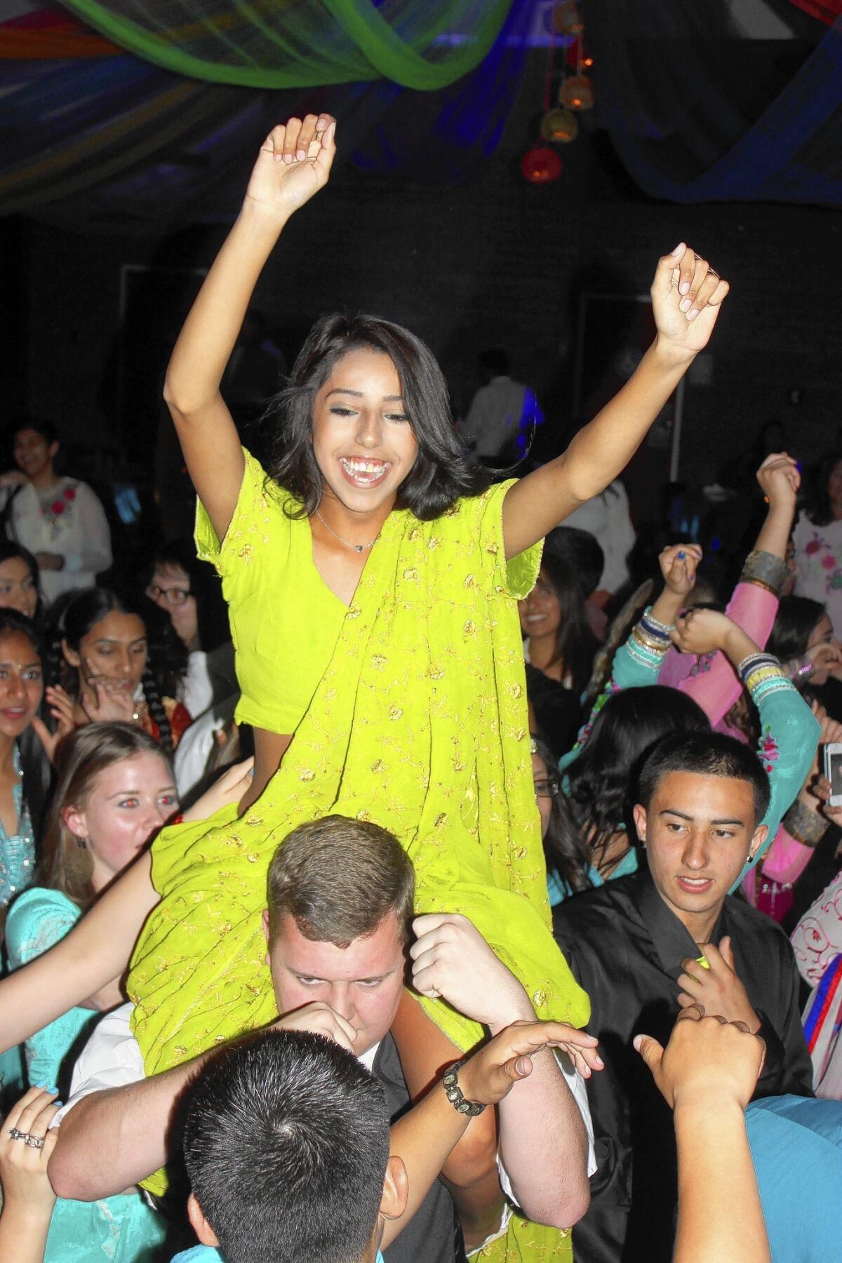 Students wearing colorful outfits get in the spirit at the Bollywood dance at Fowler High School in Fowler, Calif.
