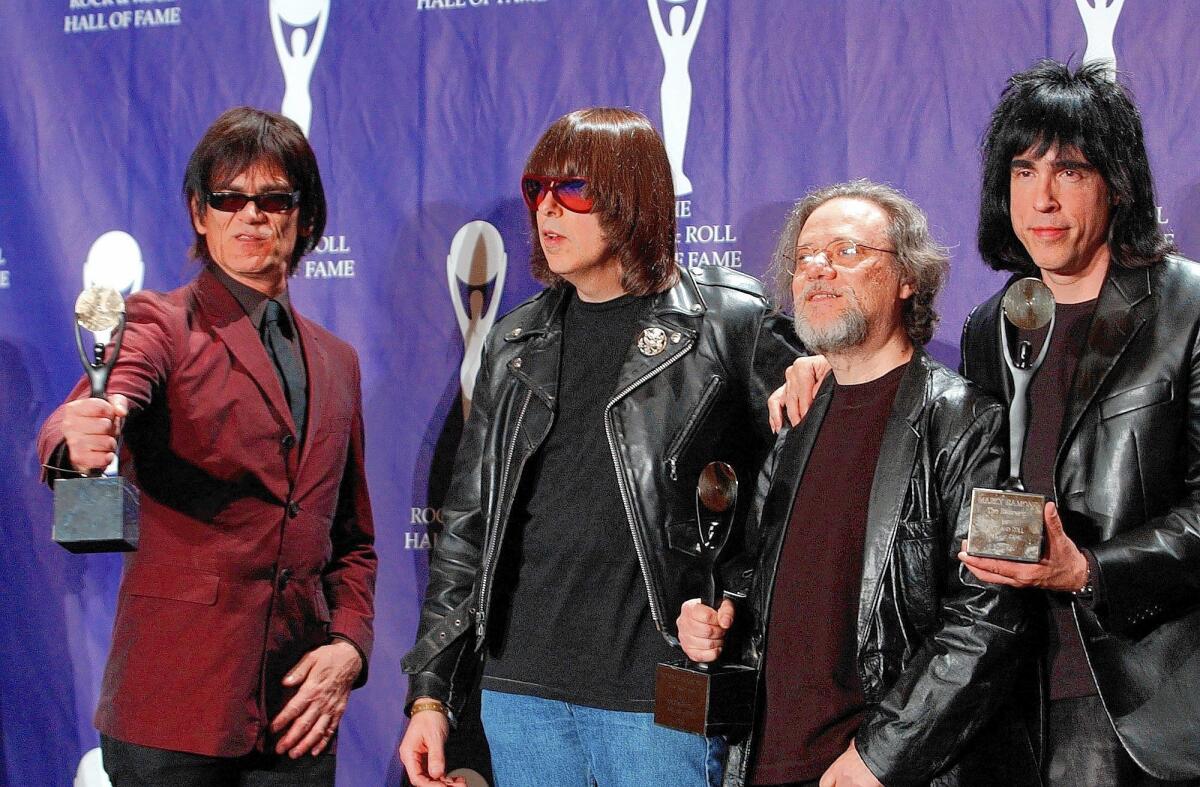 Dee Dee, left, Johnny, Tommy and Marky Ramone hold their awards after being inducted into the Rock and Roll Hall of Fame in 2002. Founding member Joey Ramone died the previous year. Tommy Ramone, the band's original drummer and its last surving member, died Friday at the age of 65.