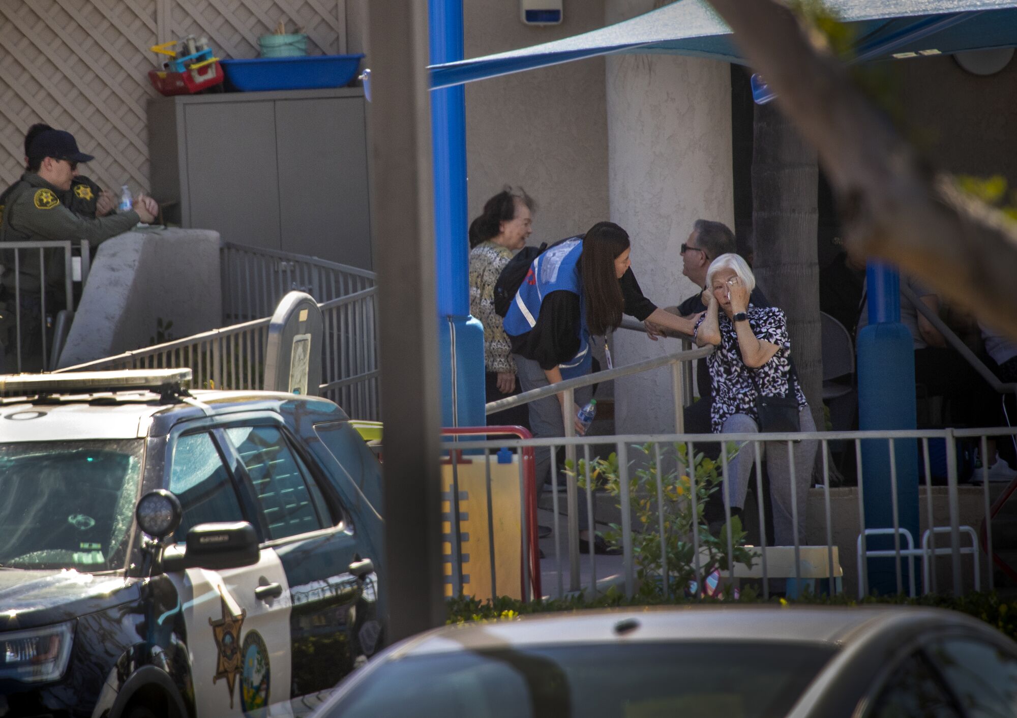 A grief counselor comforts a parishioner after a shooting Sunday at Geneva Presbyterian Church in Laguna Woods.