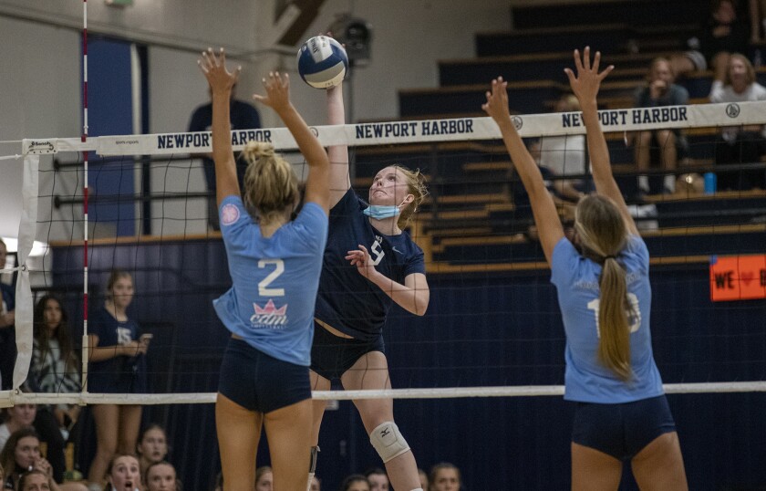 Newport Harbor's Emma Coatsworth hits against Corona del Mar's Reiley Murphy, left, and Kirsten Dauderman.