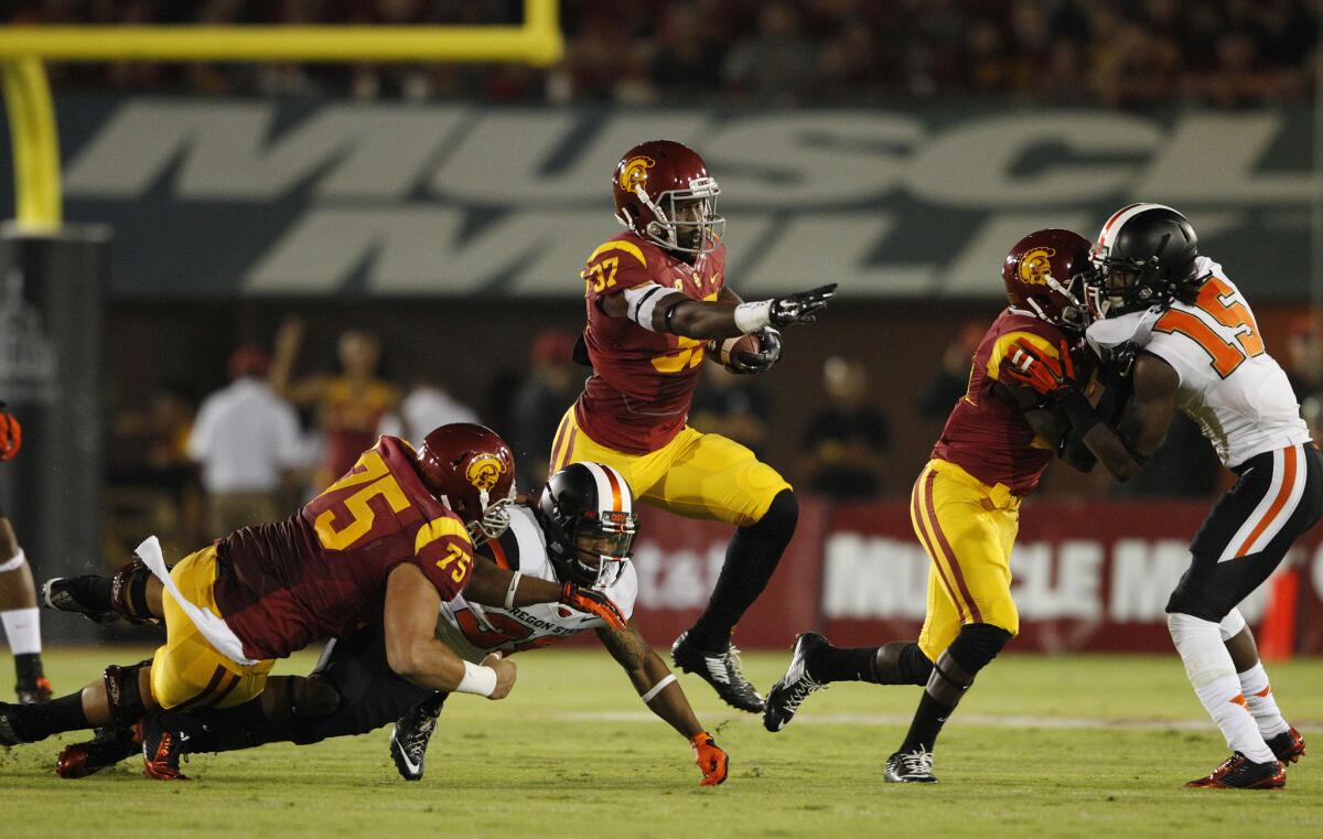 USC running back Javorius Allen gains a first down as USC Trojans center Max Tuerk, left, and receiver Ajene Harris throw blocks against Oregon State on Saturday.