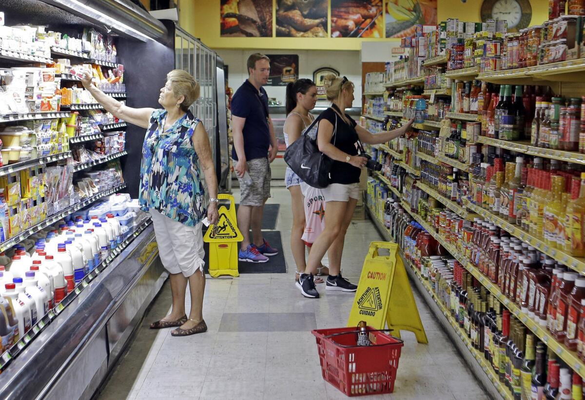 Grocery shoppers browse the merchandise at a store in the Little Havana area of Miami on June 12.
