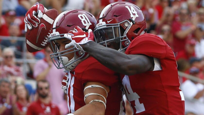 Alabama wide receiver Derek Kief, left, celebrates with wide receiver Tyrell Shavers after scoring a touchdown against Arkansas State during the second half on Saturday in Tuscaloosa, Ala. Alabama won 57-7.