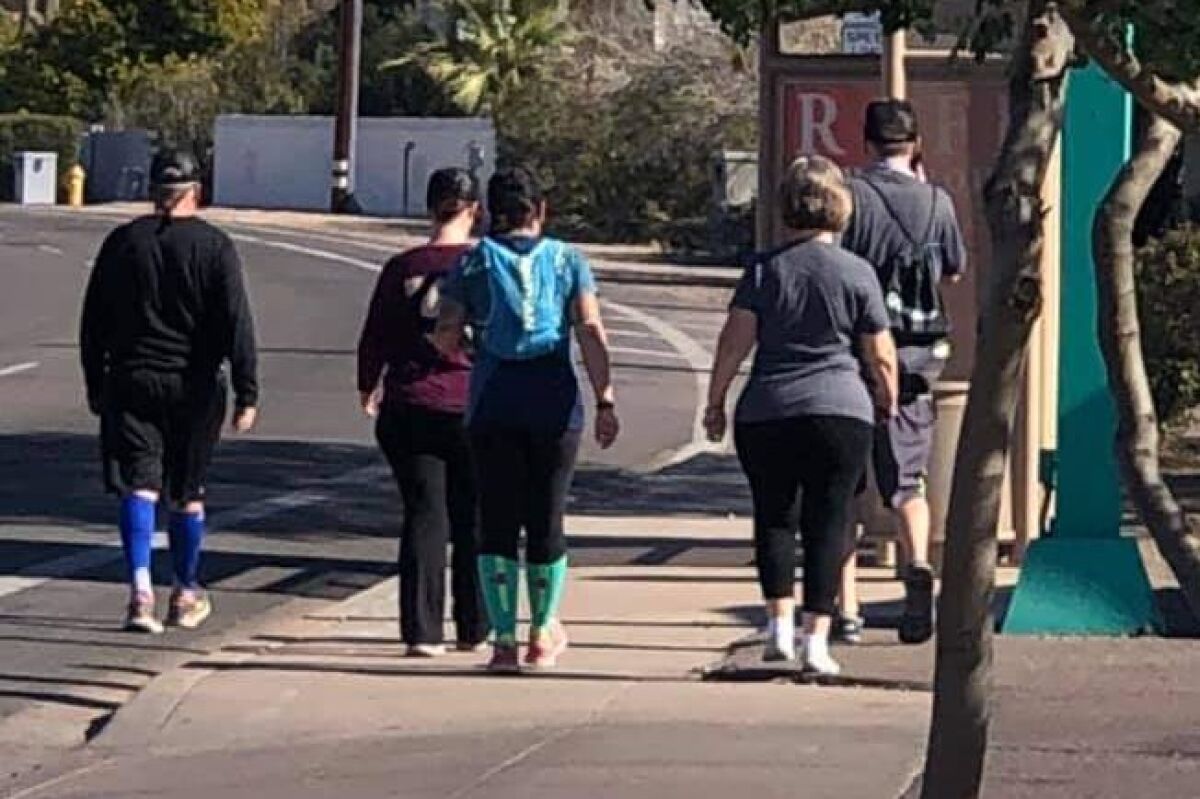 Colin Jackson, right, walks with support team on his 26.2 mile walk in Arizona on Jan. 17, 2021.