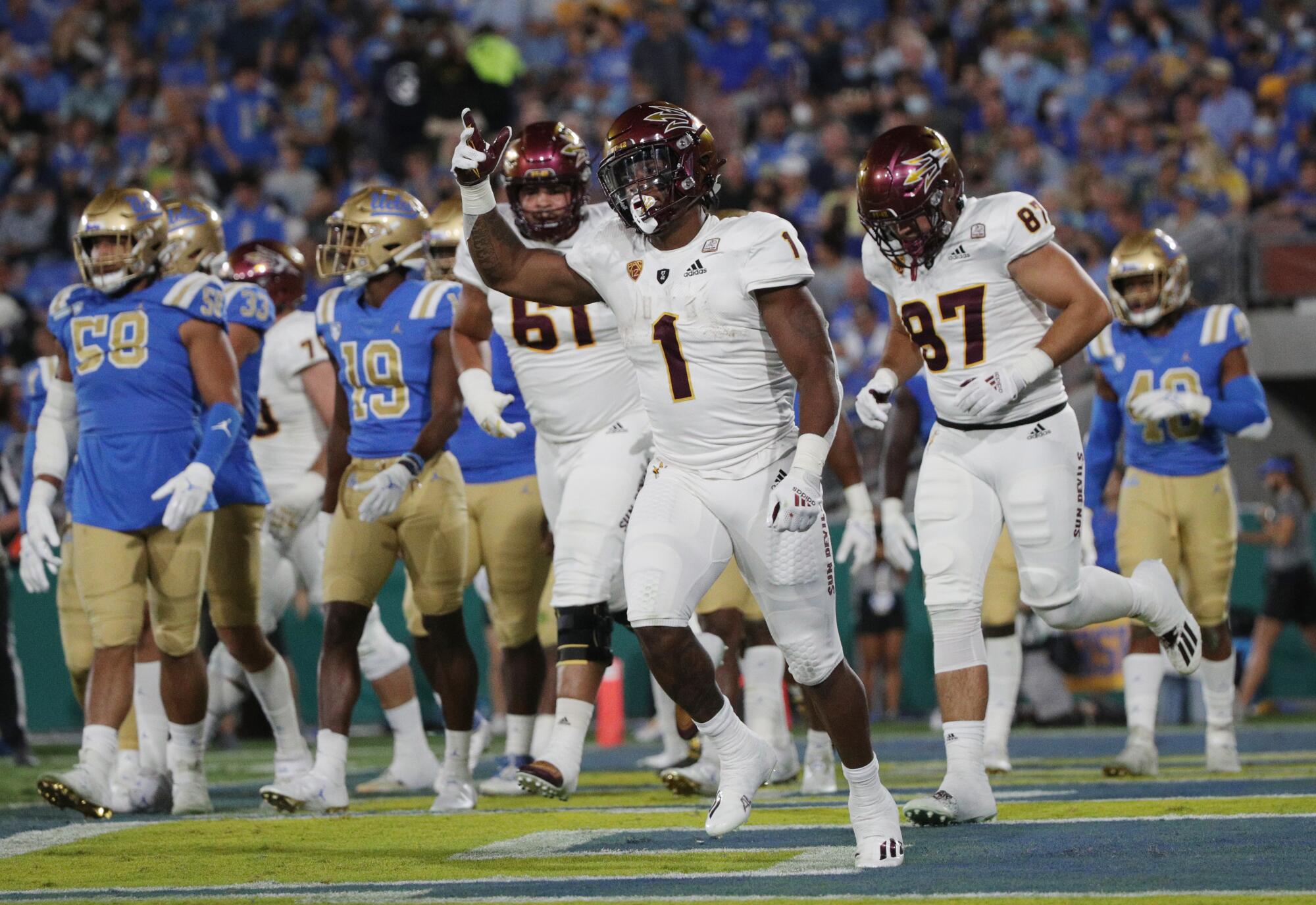 Arizona State running back DeaMonte Trayanum celebrates after scoring a first-half touchdown against UCLA.