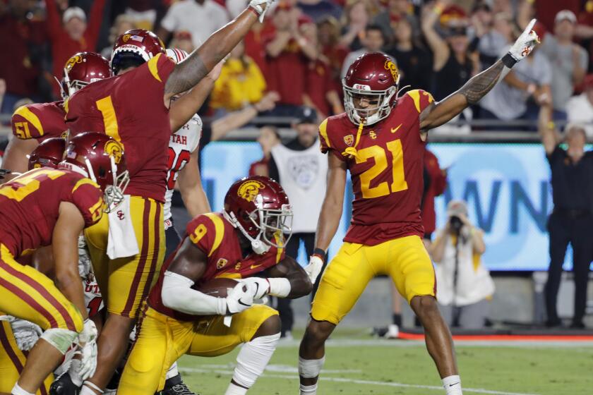 LOS ANGELES, CALIF. - SEP. 20, 2019. The USC defense celebrates after recovering a Utah fumble in the second quarter at the L.A. Memorial Coliseum on Friday night, Sep. 20, 2019. (Luis Sinco/Los Angeles Times)