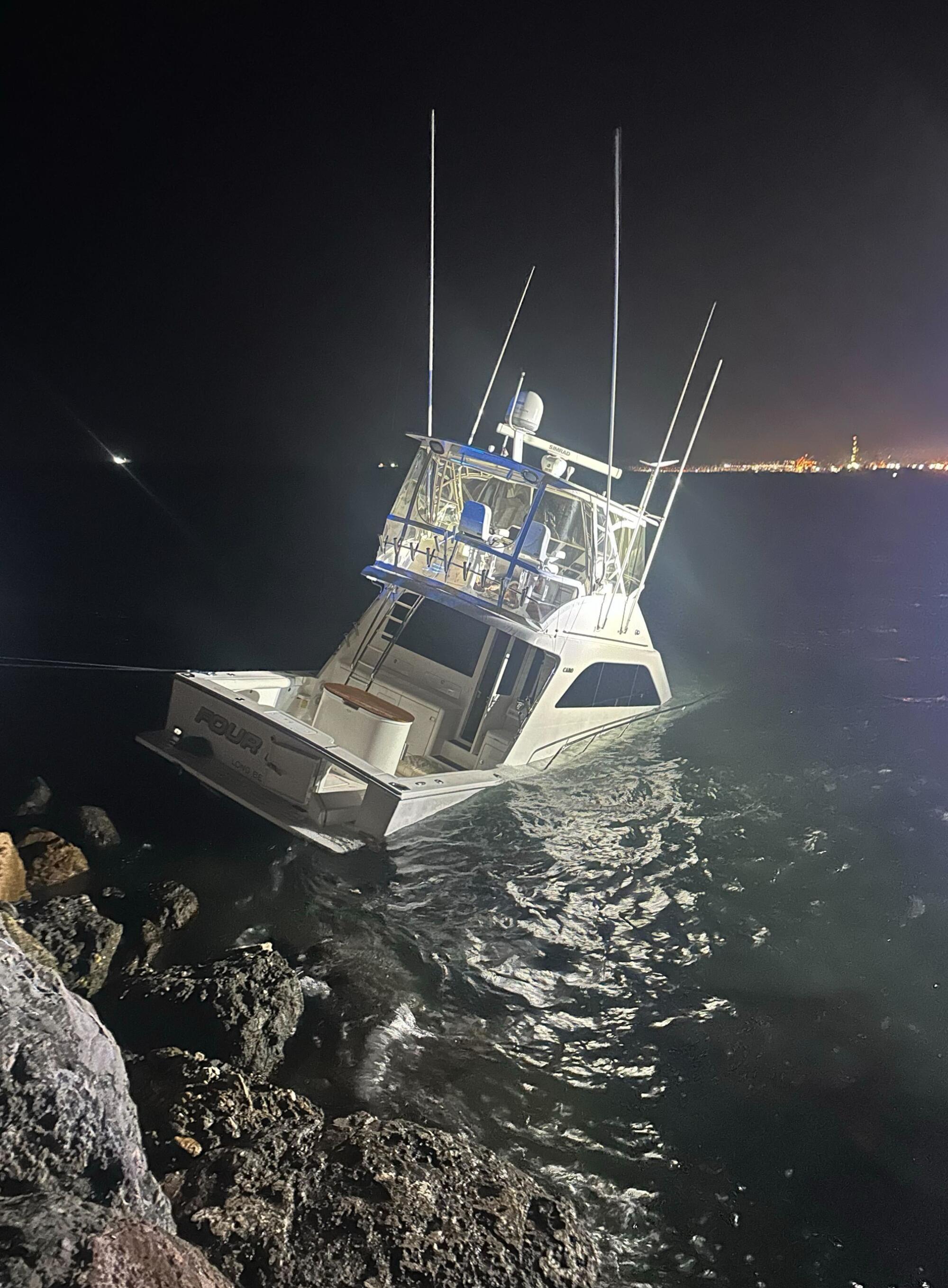 A photo shows the sinking Four Kings boat in the Long Beach harbor.