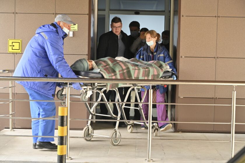 Medical staff carry an injured person on a stretcher at the emergency department of the First Republican Clinical hospital to evacuate to Moscow, in Izhevsk, Russia, Tuesday, Sept. 27, 2022. The plane of the Ministry of Emergency Situations will deliver victims of the shooting at school No. 88 in Izhevsk to Moscow hospitals. This was stated by the Presidential Commissioner for Children's Rights Maria Lvova-Belova. According to officials, 11 children were among those killed in the Monday morning shooting in School No. 88 in Izhevsk, a city 960 kilometers (600 miles) east of Moscow. (AP Photo/Dmitry Serebryakov)