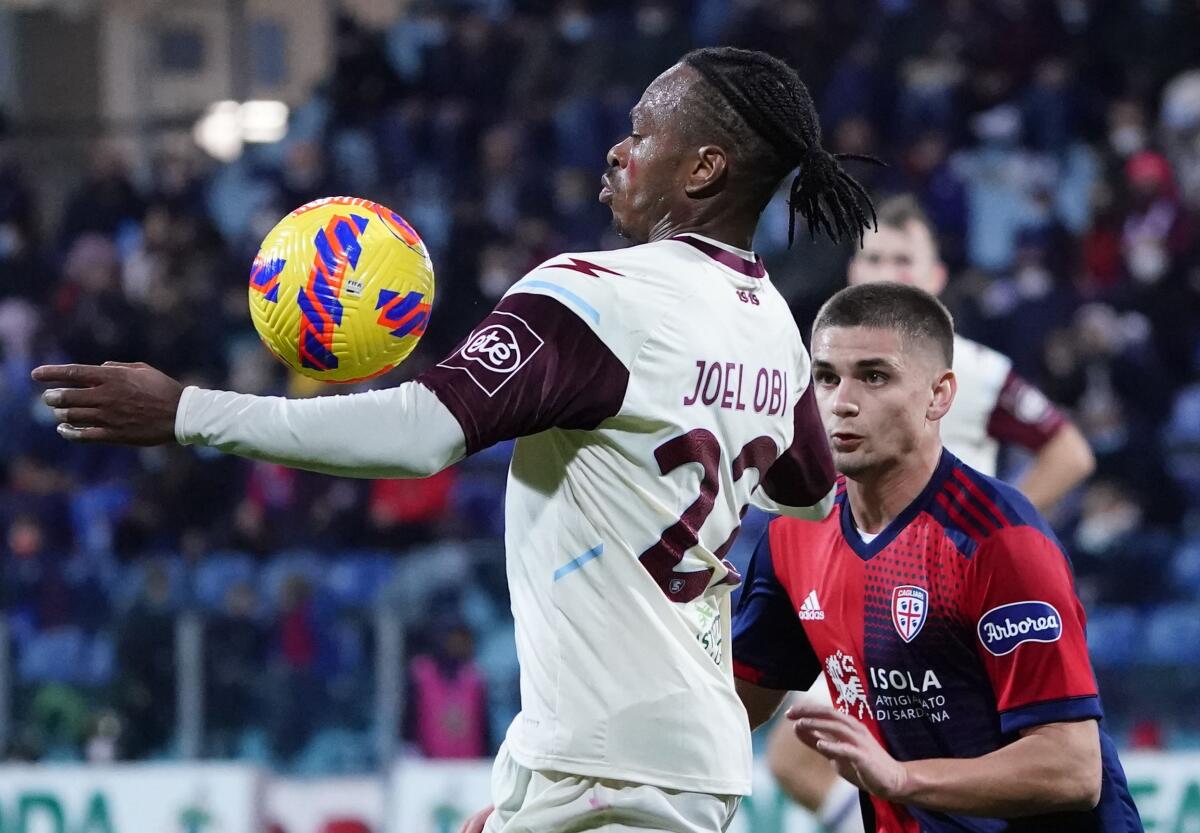 Salernitana's Joel Obi, left, and Cagliari's Razvan Marin battle for the ball during an Italian Serie A soccer match between Cagliari and Salernitana at the Unipol Domus stadium in Cagliari, Italy, Friday, Nov. 26, 2021. (Alessandro Tocco/LaPresse via AP)