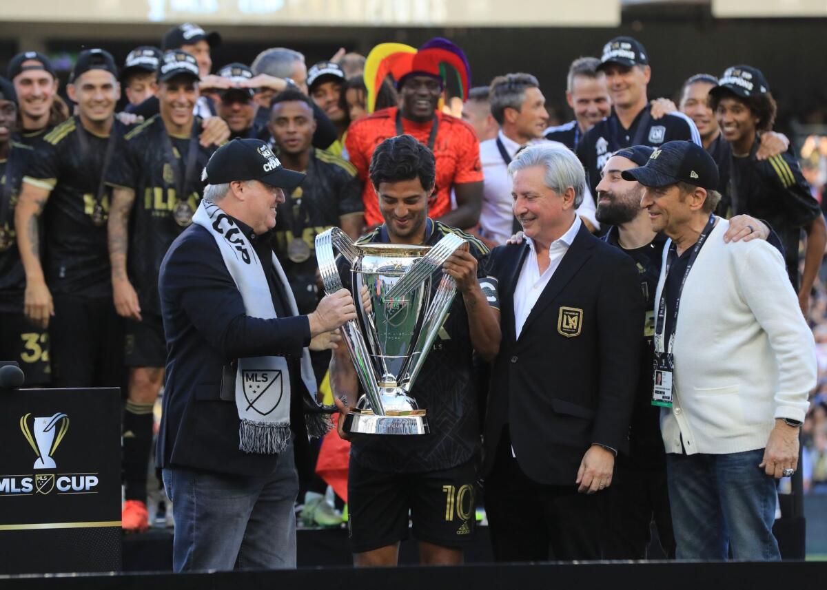 Carlos Vela receives the MLS Cup, his first league title in his career.