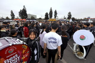The Kyoto Tachibana Senior High School Green Band listen to their music director during rehearsal.