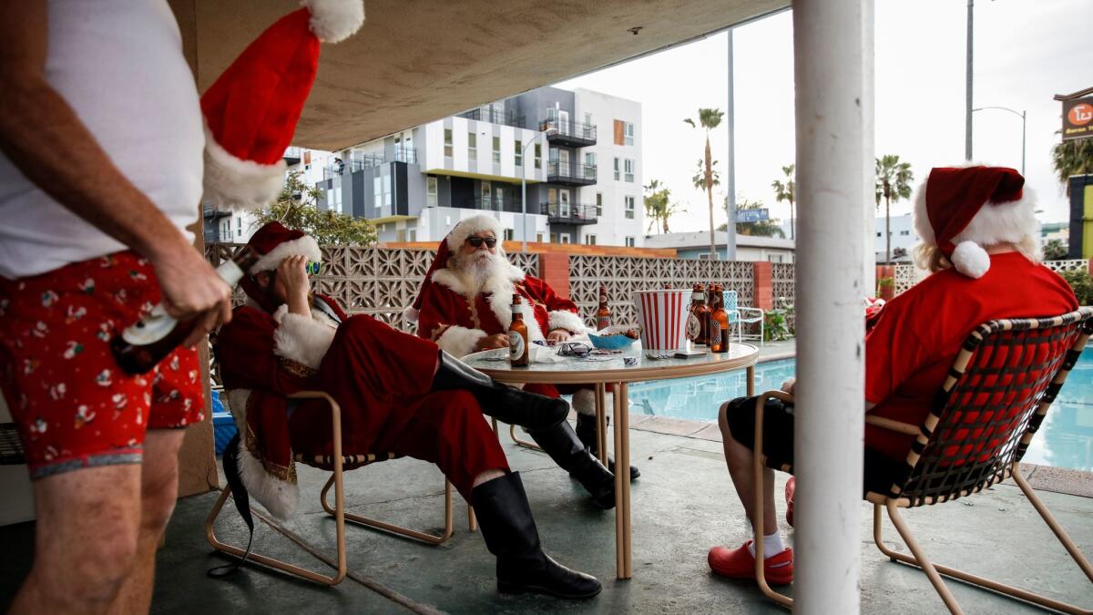 Background actors in Santa costumes get into position at a motel in Hollywood during filming of FX's "Fargo." (Jay L. Clendenin / Los Angeles Times)