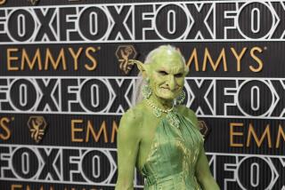 A person dressed as a green goblin wearing a green gown.  