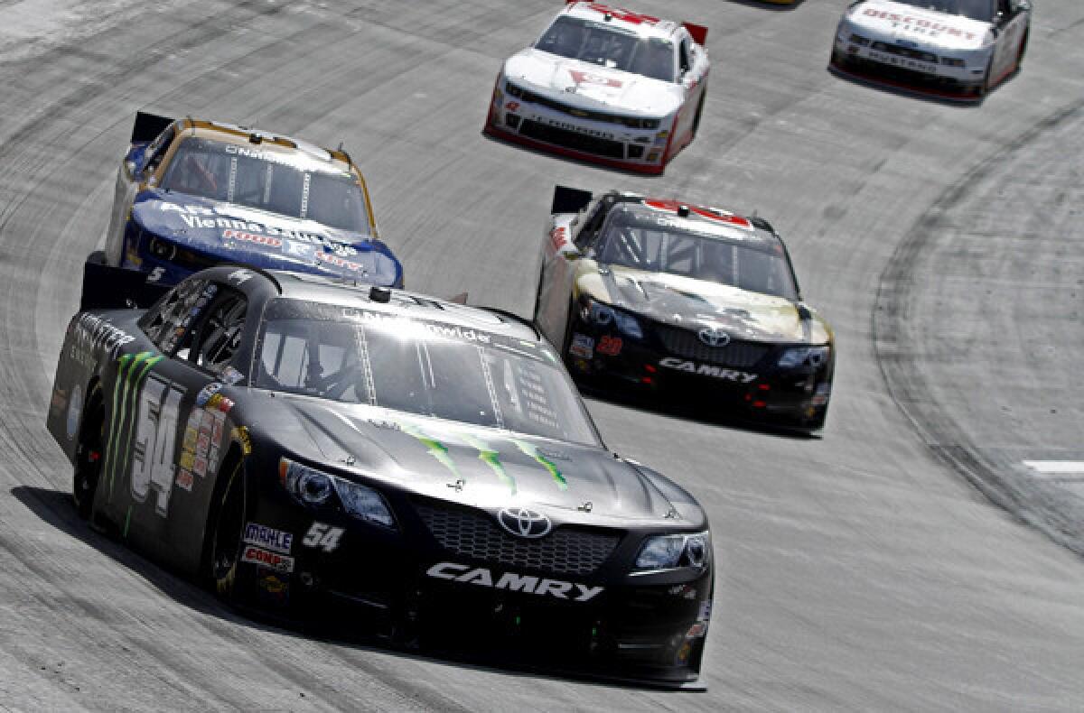NASCAR driver Kyle Busch, in the No. 54 Toyota, leads Matt Kenseth (20) and Kevin Harvick (5) during the Nationwide Series race Saturday at Bristol Motor Speedway.