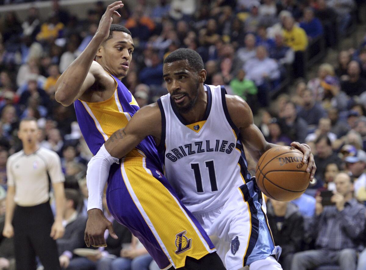 Grizzlies guard Mike Conley (11) drives against Lakers guard Jordan Clarkson during the second half on Wednesday.