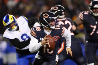 Chicago Bears quarterback Caleb Williams rolls out of the pocket in overtime.