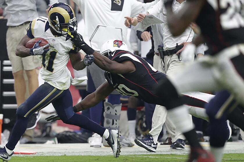 Rams punt returner Tavon Austin is pulled down by the facemask by Cardinals tight end Ifeanyi Momah, giving the Rams good field position for a fourth-quarter drive Sunday.