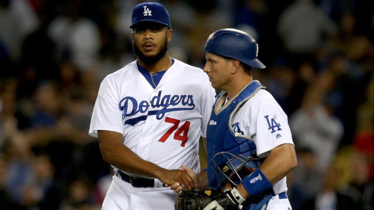 Dodgers catcher A.J. Ellis congratulates closer Kenley Jansen (74) after a 5-1 victory over the Angels on May 17.