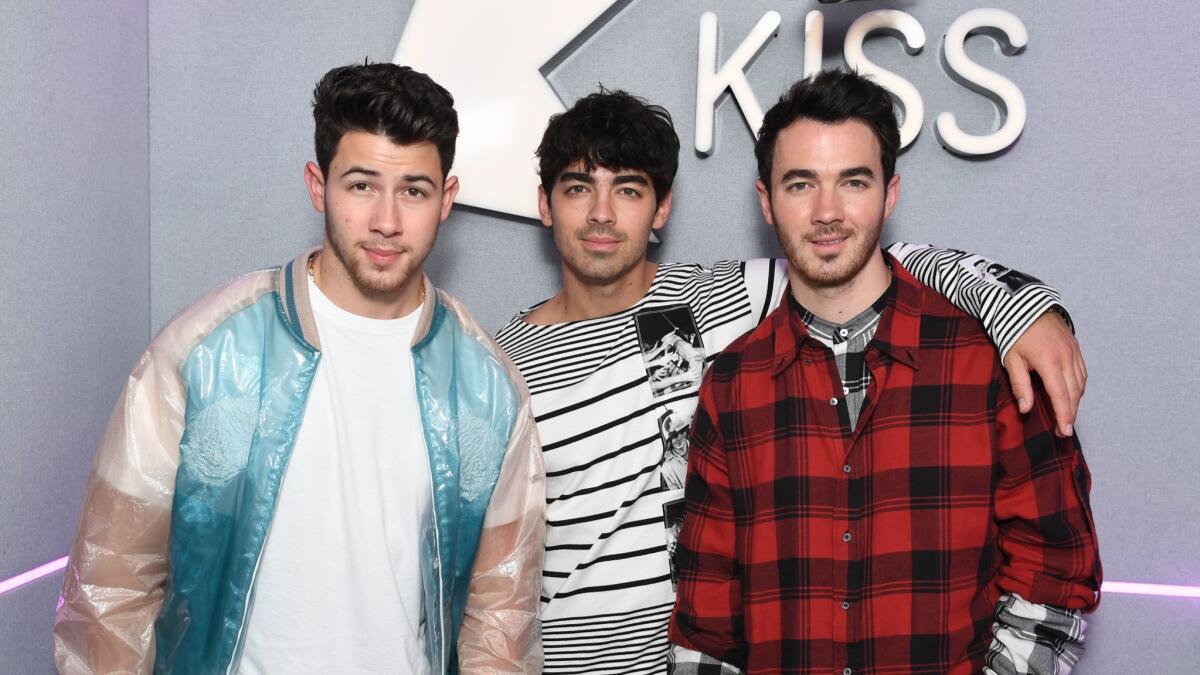 Nick Jonas, left, Joe Jonas and Kevin Jonas visit the Kiss FM Studios on May 29 in London.