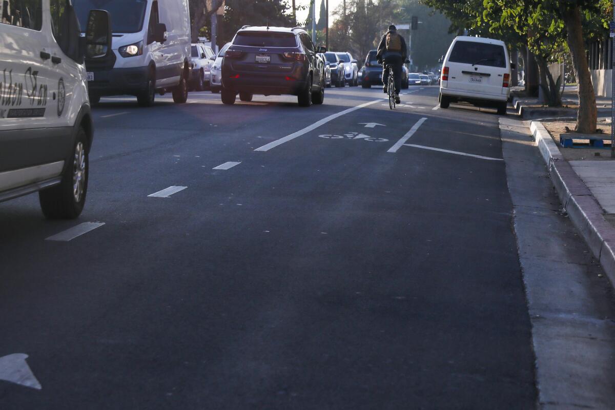 A cyclist uses the bike lane next to cars along Fountain Avenue in Hollywood.