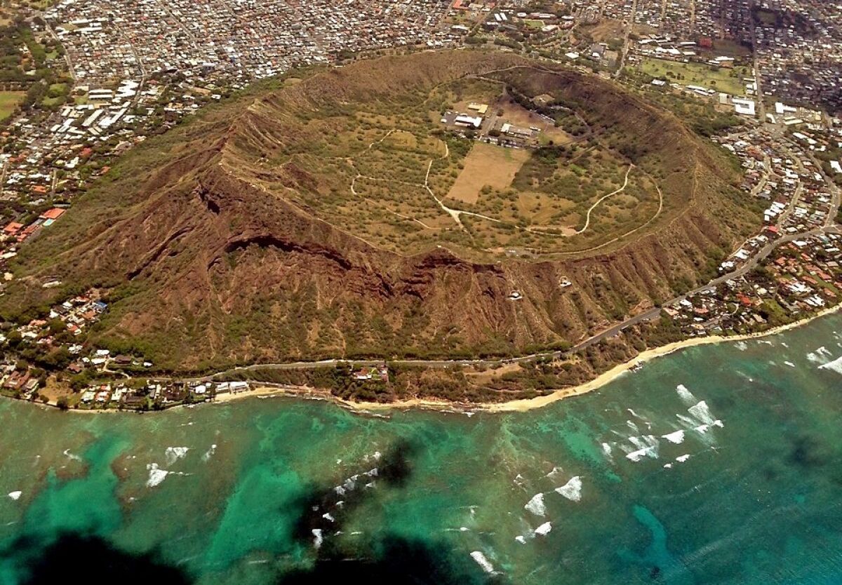 A STUNNING AERIAL SHOT of Diamond Head State Monument on Oahu reveals the circular crater, thought to have originated as many as a half-million years ago in a series of explosive volcanic blasts. The diameter of the crater is about 3,500 feet. Arnie Cooper