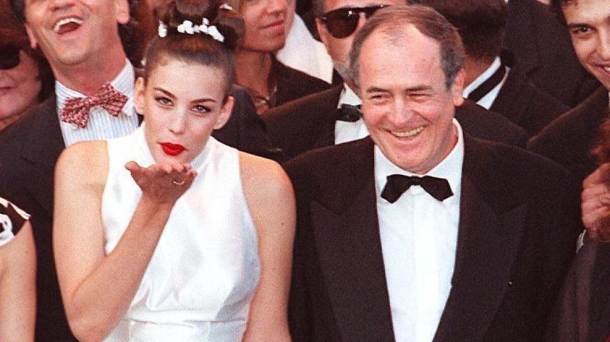 "Stealing Beauty" actress Liv Tyler, left, with director Bernardo Bertolucci sends a kiss to the photographers at the Palais des Festivals of Cannes during the Cannes International Film Festival in May 1996.