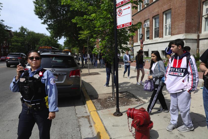 A Chicago police officer monitors Lake View High School dismissal on June 6, 2019. The high school is the regular daily beat for this officer, she said.